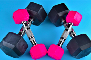 Two pairs of black and pink hand weights in an "x"shape.